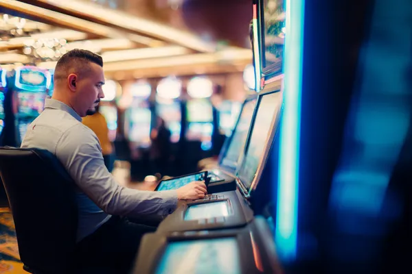 A young woman relaxing with her phone while dynamic casino elements float around her, illustrating the smooth mobile experience offered by the HOKI678 app.