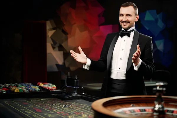 A glowing roulette wheel with cascading chips, symbolizing the engaging live and instant-win games available on HOKI678.